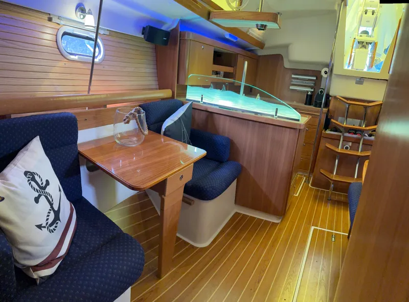 Slide: The Image of Interior of 2010 Catalina 350 sailboat with wooden furnishings and cozy seating area. - 22