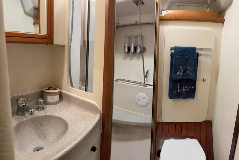 Slide: The Image of Bathroom interior of a 2010 Catalina 350 yacht with sink, shower, and toilet. - 28