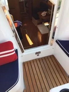 Slide: The Image of Catalina 350 sailboat interior, 2010 model, featuring wooden flooring and cushioned seating. - 3