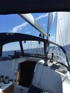 Slide: The Image of 2010 Catalina 350 sailboat on open water under clear blue sky. - 4