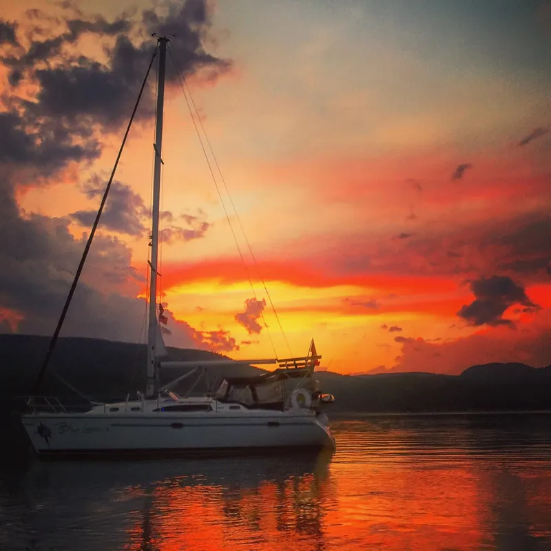 Slide: The Image of Catalina 350 sailboat at sunset, reflecting on calm water, 2010 model. - 6