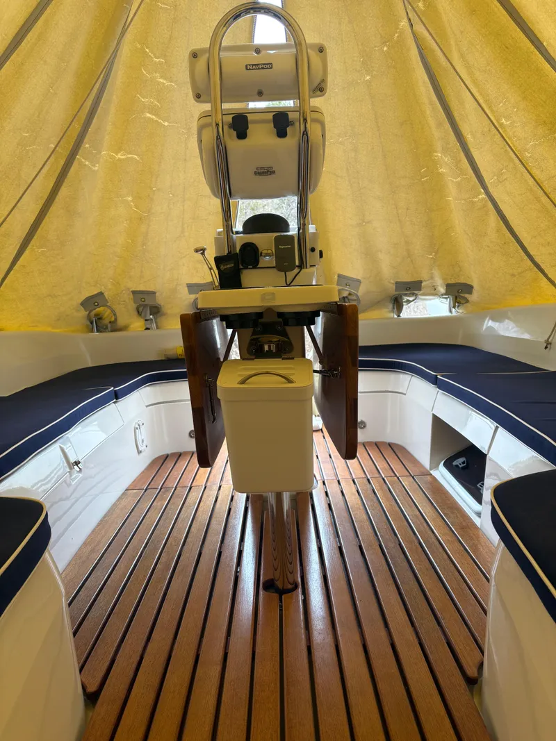 Slide: The Image of 2010 Catalina 350 sailboat interior with wooden flooring and seating under a canopy. - 7