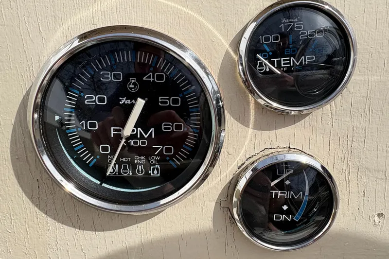 Slide: The Image of Gauges on a 1984 Boston Whaler 170 Super Sport boat dashboard, showing RPM, temperature, and trim. - 10