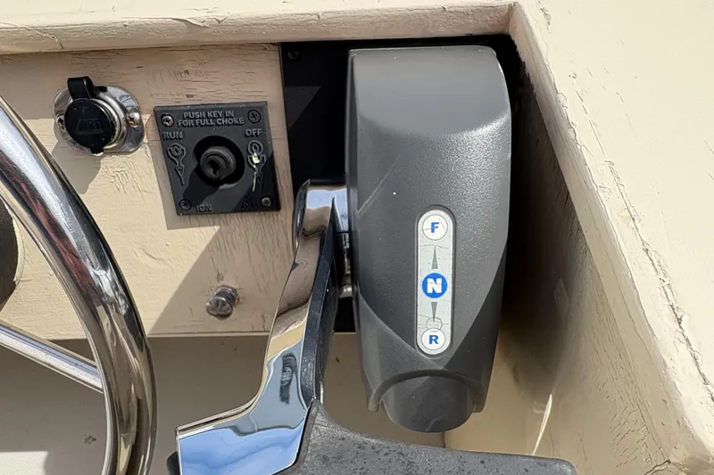 Slide: The Image of 1984 Boston Whaler 170 Super Sport boat throttle and control panel close-up. - 11