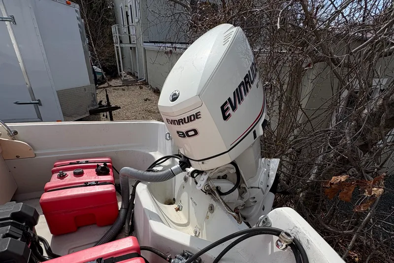 Slide: The Image of 1984 Boston Whaler 170 Super Sport with Evinrude 90 outboard motor and red fuel tanks. - 13