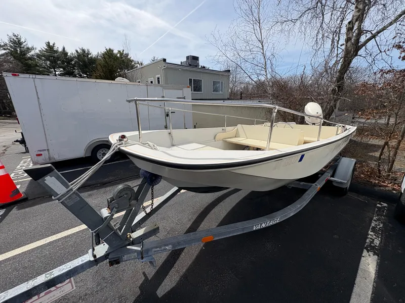 Slide: The Image of 1984 Boston Whaler 170 Super Sport boat on trailer in parking lot. - 3