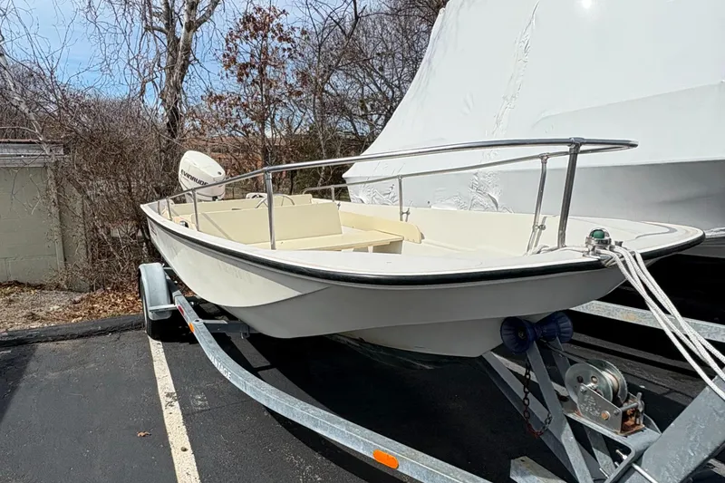 Slide: The Image of 1984 Boston Whaler 170 Super Sport boat on trailer, parked outdoors. - 4