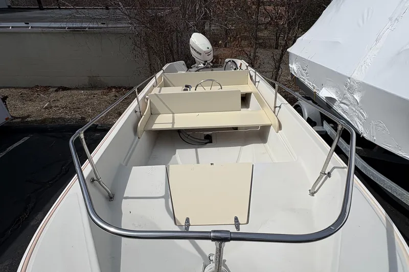 Slide: The Image of 1984 Boston Whaler 170 Super Sport boat, interior view with steering console and seating. - 7