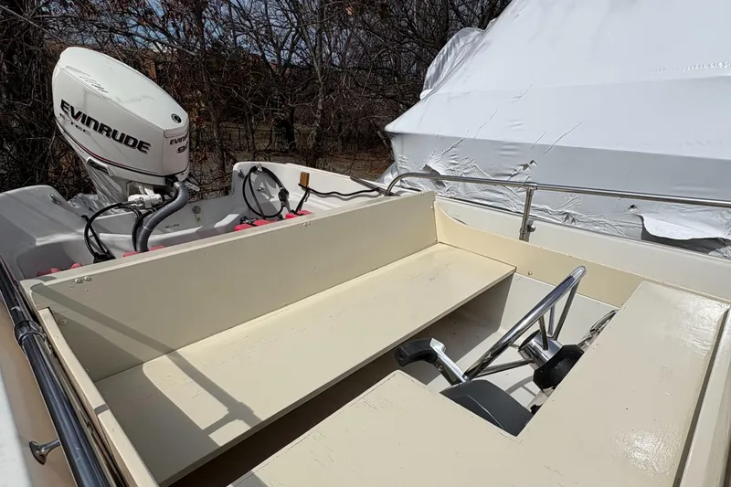 Slide: The Image of 1984 Boston Whaler 170 Super Sport boat interior with Evinrude outboard motor. - 8