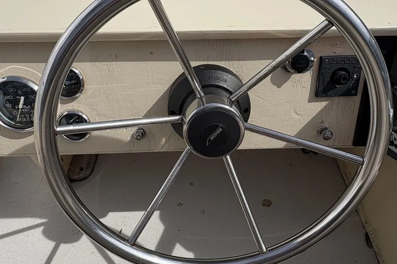 Slide: The Image of Steering wheel of a 1984 Boston Whaler 170 Super Sport boat, showcasing classic design. - 9