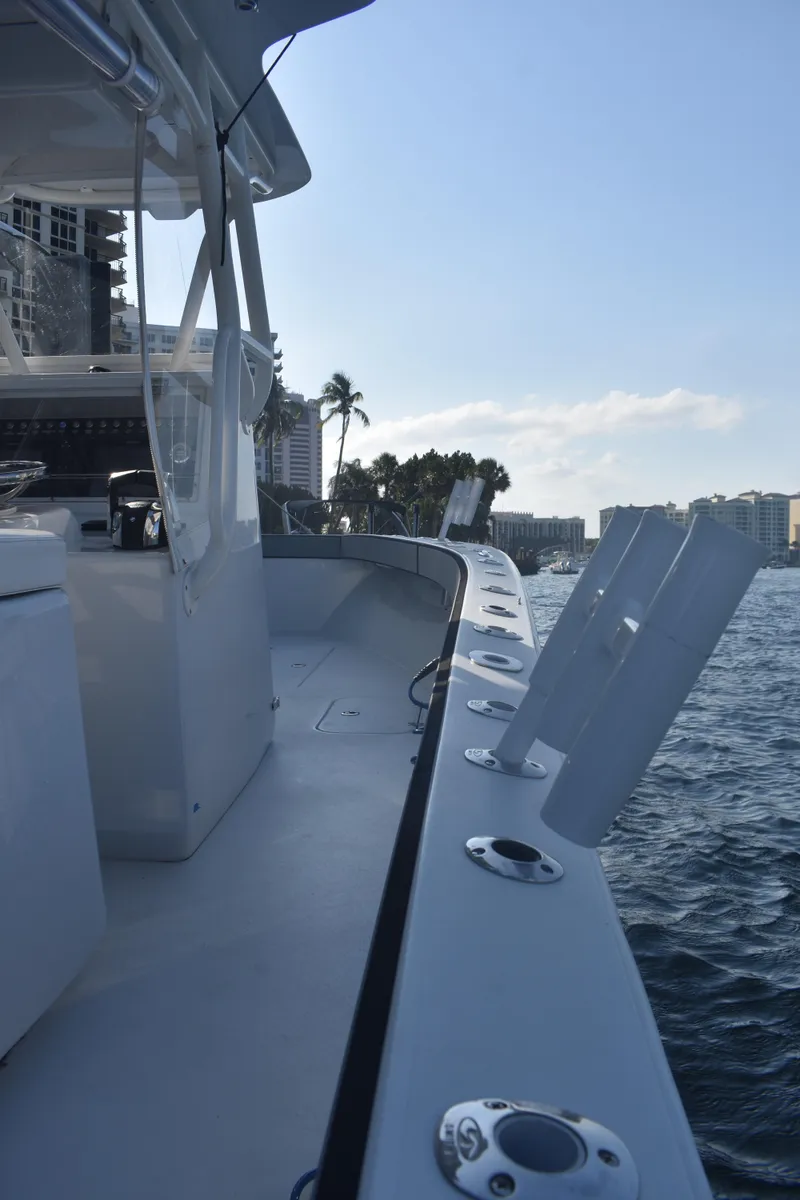 Slide: The Image of 2017 Conch 30 boat on water, featuring sleek design and rod holders. - 11