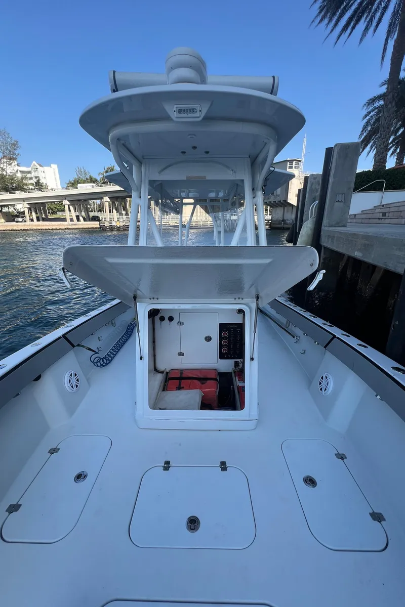 Slide: The Image of 2017 Conch 30 boat with open deck and console, docked by the waterfront. - 14