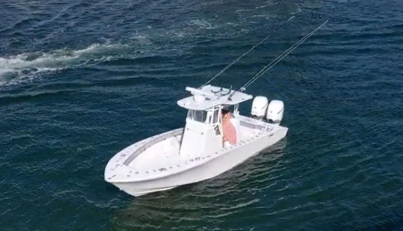 Slide: The Image of 2018 Conch 30 boat on open water with dual engines and fishing rods. - 20
