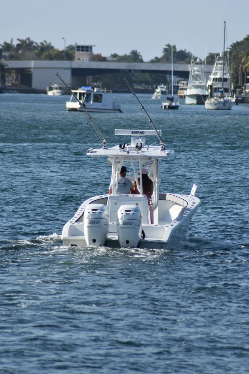 Slide: The Image of 2017 Conch 30 boat cruising on a sunny day with fishing rods. - 22