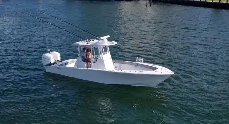 Slide: The Image of 2018 Conch 30 boat on water, equipped with fishing rods and dual engines. - 24