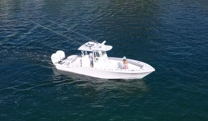 Slide: The Image of 2018 Conch 30 boat cruising on open water with fishing rods. - 25