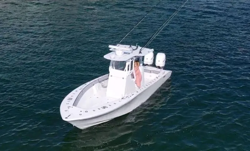 Slide: The Image of 2018 Conch 30 boat on open water, featuring dual engines and fishing equipment. - 3