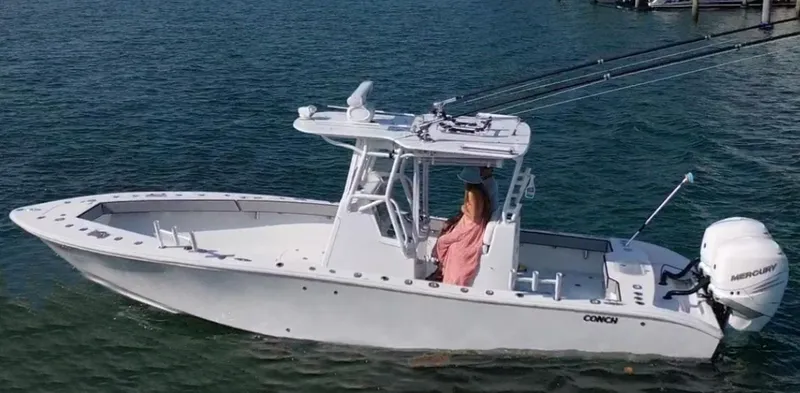 Slide: The Image of A 2018 Conch 30 boat with a Mercury engine cruising on the water. - 4
