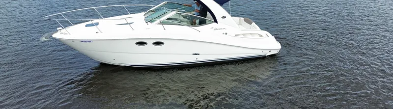 Slide: The Image of 2007 Sea Ray 290 Sundancer boat on calm water. - 3