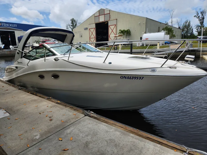 Slide: The Image of 2007 Sea Ray 290 Sundancer docked at marina, with warehouse in background. - 6
