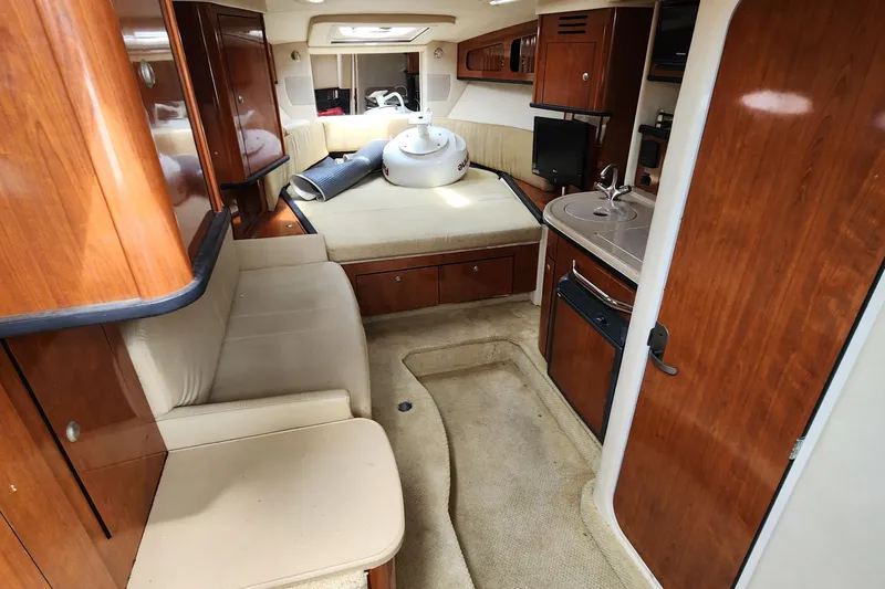 Slide: The Image of Interior of 2007 Sea Ray 290 Sundancer boat with wood finish and cozy seating. - 9