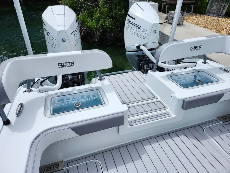 Slide: The Image of Costa Custom Boats 264 HC 2022 model with dual engines and sleek deck design. - 14