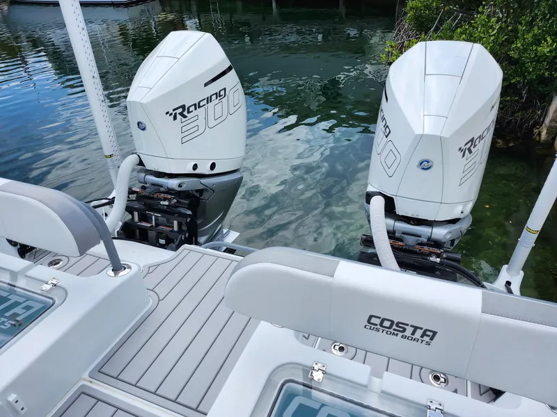 Slide: The Image of 2022 Costa Custom Boats 264 HC with twin Racing 300 engines on clear water. - 15