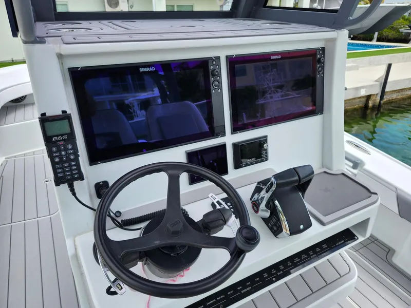 Slide: The Image of 2022 Costa Custom Boats 264 HC helm with dual Simrad displays and steering wheel. - 23