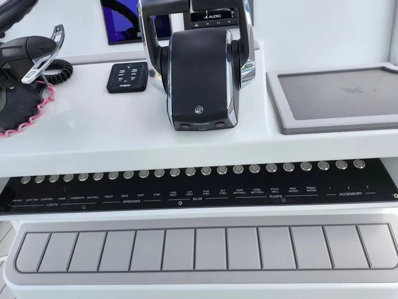 Slide: The Image of Control panel of 2022 Costa Custom Boats 264 HC with switches and throttle. - 25