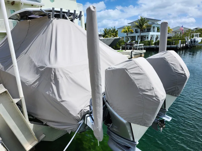 Slide: The Image of Covered 2022 Costa Custom Boats 264 HC docked by waterfront homes. - 26