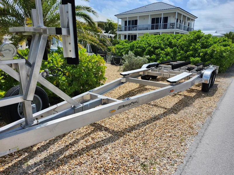 Slide: The Image of Trailer for 2022 Costa Custom Boats 264 HC, parked on gravel near a house. - 29