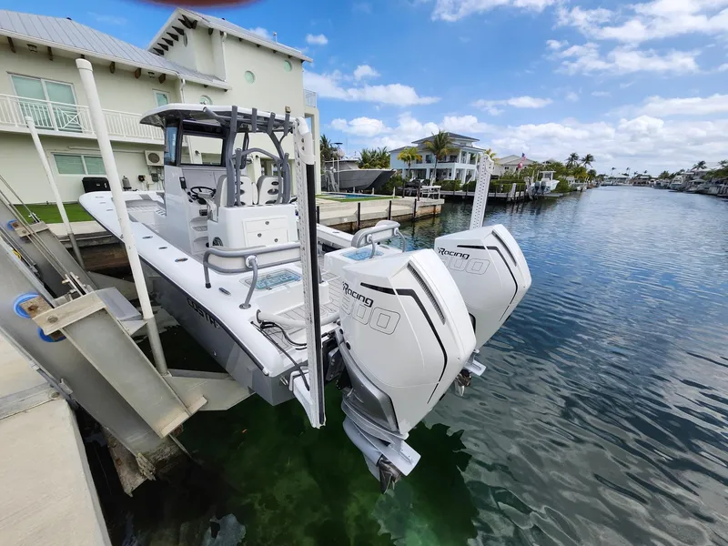 Slide: The Image of 2022 Costa Custom Boats 264 HC docked by a canal with twin engines. - 3