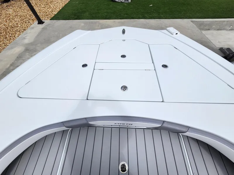 Slide: The Image of 2022 Costa Custom Boats 264 HC deck, sleek design with storage compartments. - 7