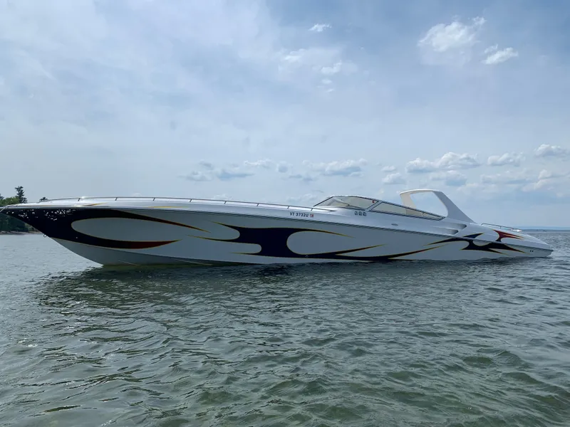 Slide: The Image of 2005 Fountain 47 Lightning speedboat on calm water under a partly cloudy sky. - 1