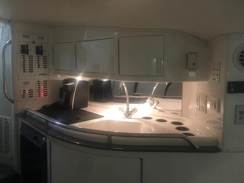 Slide: The Image of 2005 Fountain 47 Lightning boat interior with modern kitchen amenities and sleek design. - 10