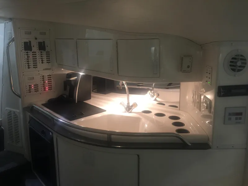Slide: The Image of 2005 Fountain 47 Lightning boat interior with kitchenette and modern amenities. - 11