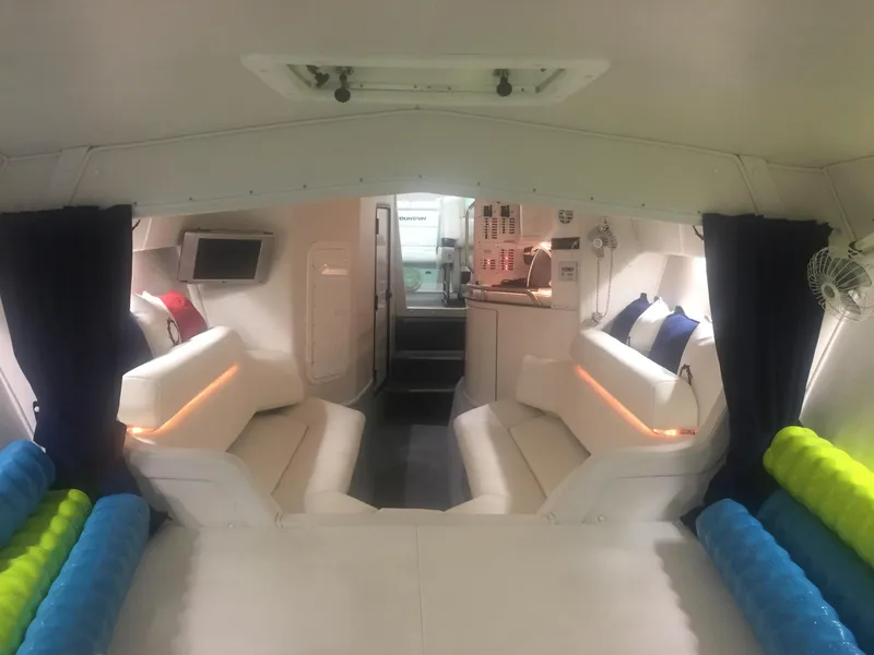 Slide: The Image of Interior of 2005 Fountain 47 Lightning boat with white seating and colorful cushions. - 13