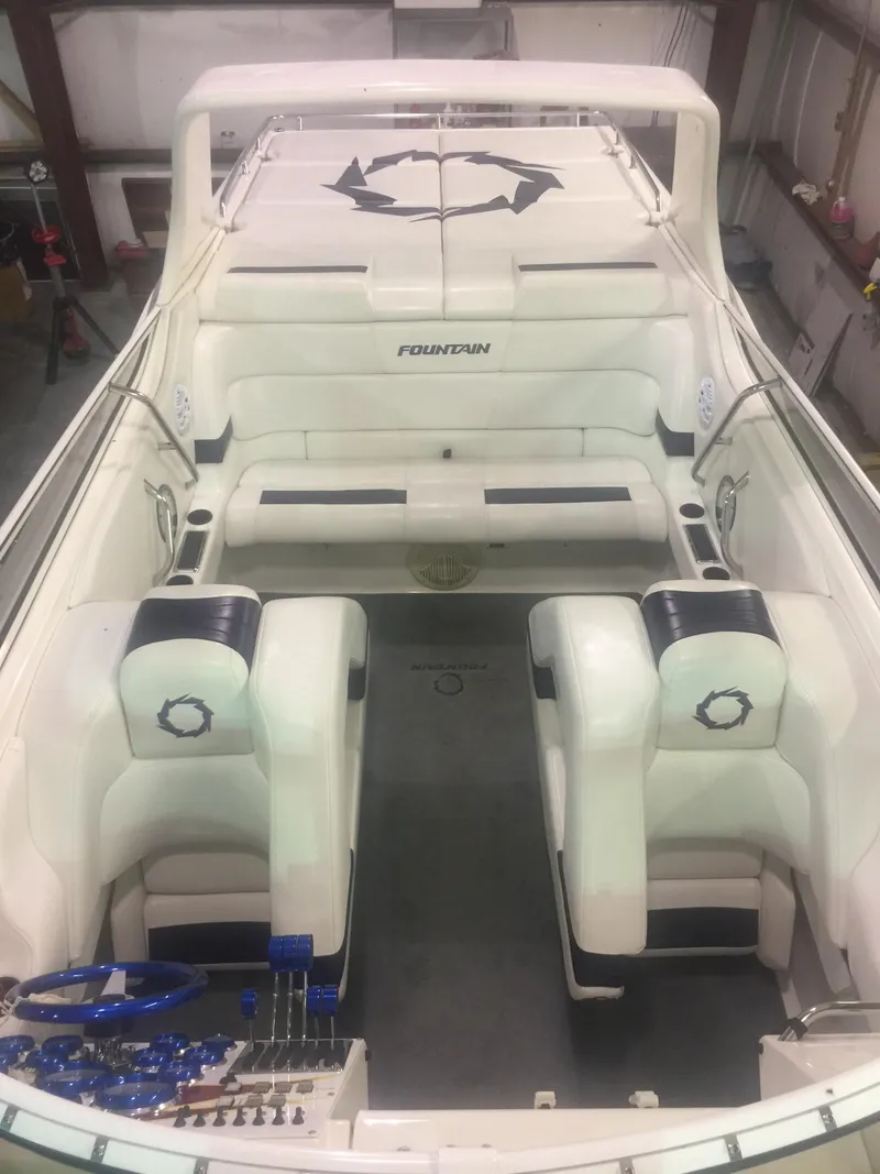 Slide: The Image of 2005 Fountain 47 Lightning boat interior with white seating and steering controls. - 4
