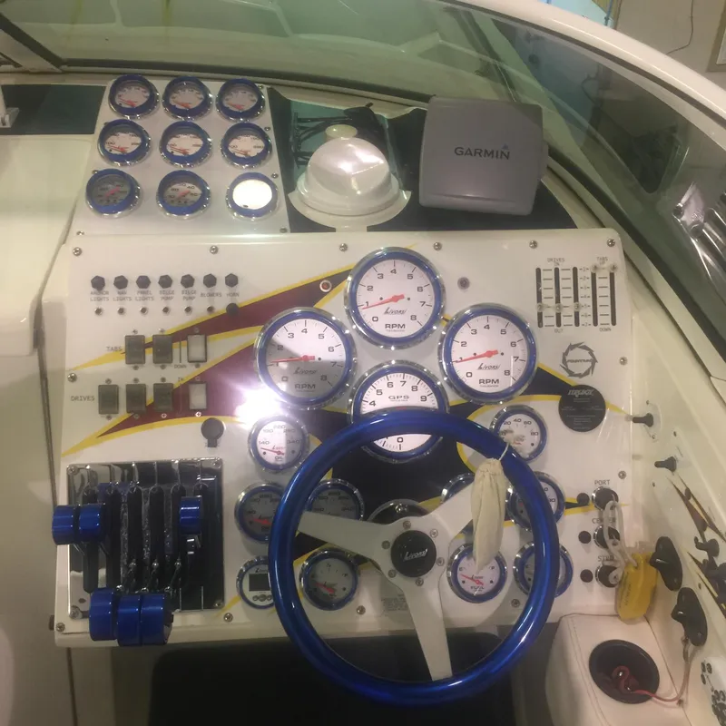 Slide: The Image of Control panel of a 2005 Fountain 47 Lightning boat with gauges and Garmin device. - 7