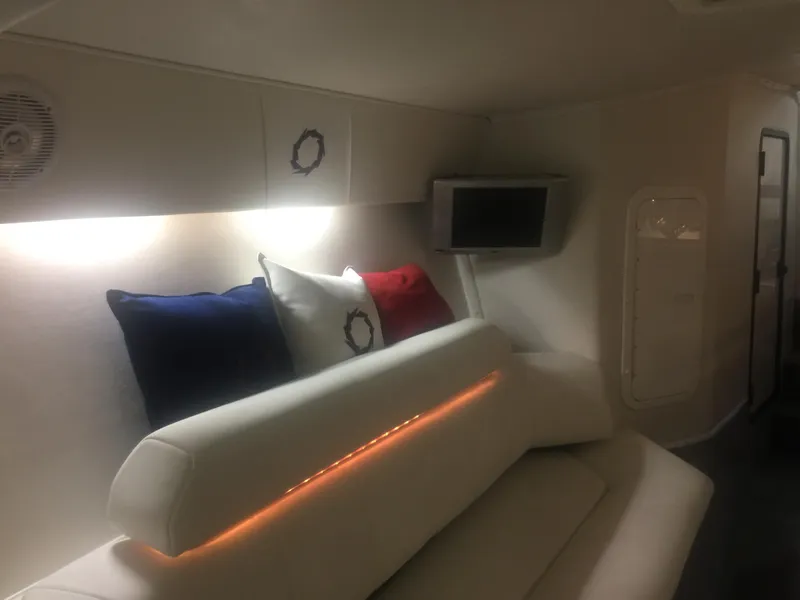 Slide: The Image of Interior of 2005 Fountain 47 Lightning boat with white seating and colorful cushions. - 9