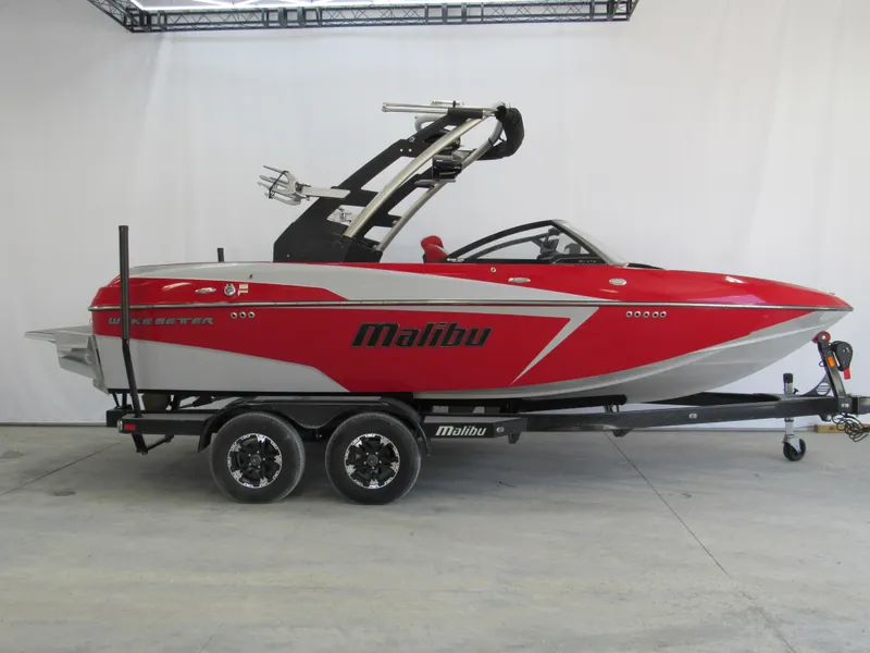 Slide: The Image of 2019 Malibu Wakesetter 20 VTX boat on trailer, red and white design. - 0