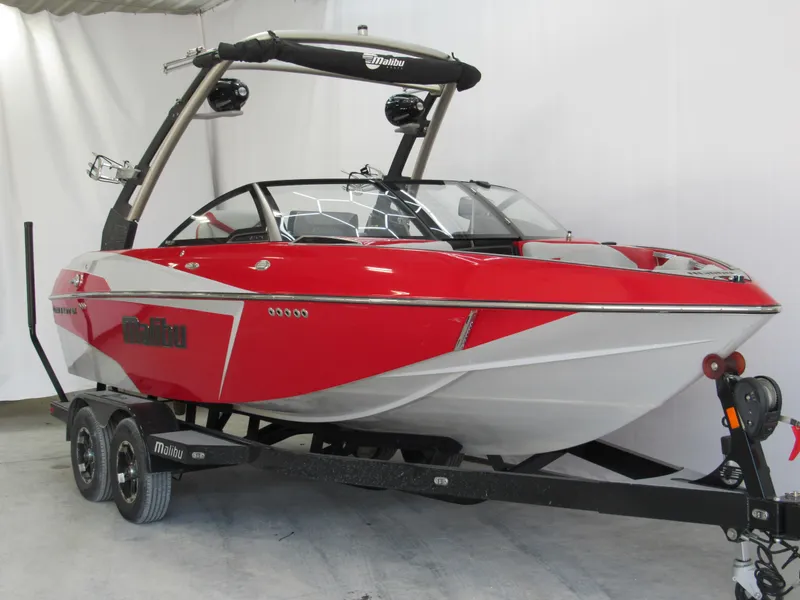 Slide: The Image of 2019 Malibu Wakesetter 20 VTX boat in red and white on a trailer. - 1