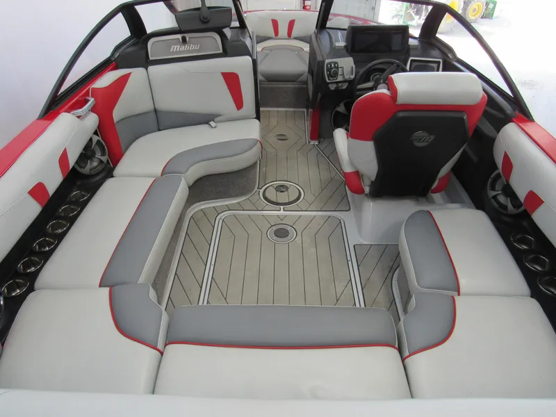 Slide: The Image of 2019 Malibu Wakesetter 20 VTX interior with red and gray seating, modern dashboard. - 3