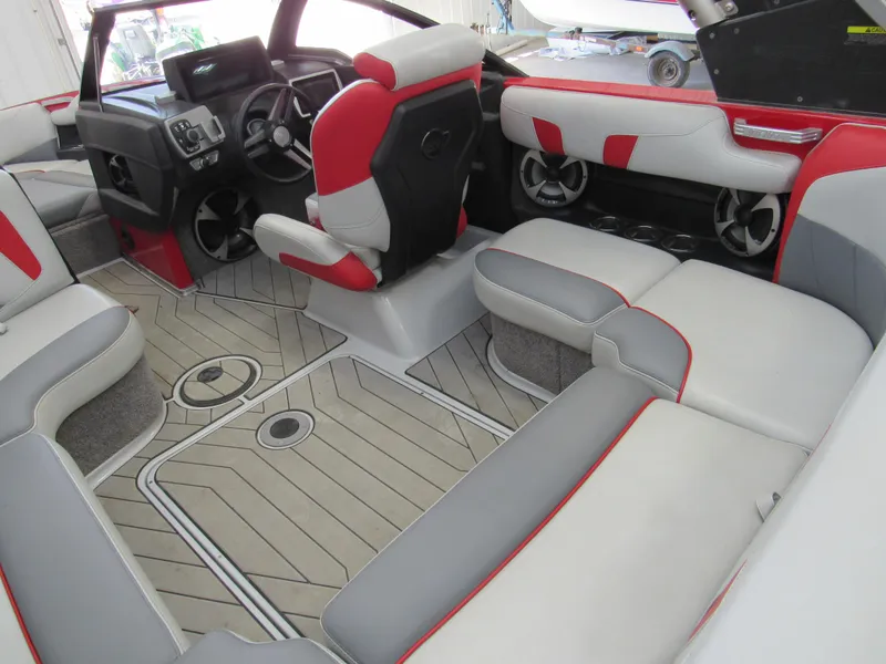 Slide: The Image of 2019 Malibu Wakesetter 20 VTX interior with red and gray seating, modern dashboard, and spacious layout. - 4