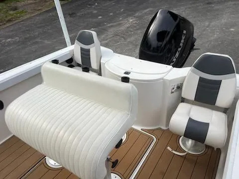 Slide: The Image of 2001 Seaswirl Striper 2101 Center Console O/B with white seating and outboard motor. - 6