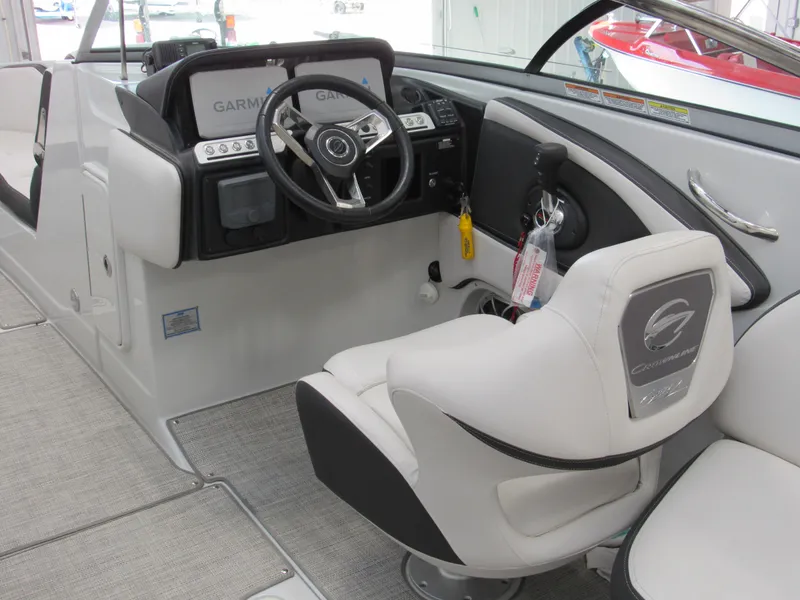 Slide: The Image of 2023 Crownline 270 SS boat interior with steering wheel and captain's seat. - 8