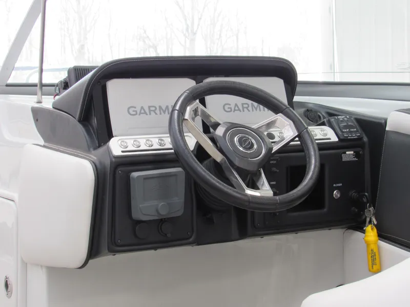 Slide: The Image of 2023 Crownline 270 SS boat dashboard with Garmin displays and steering wheel. - 9
