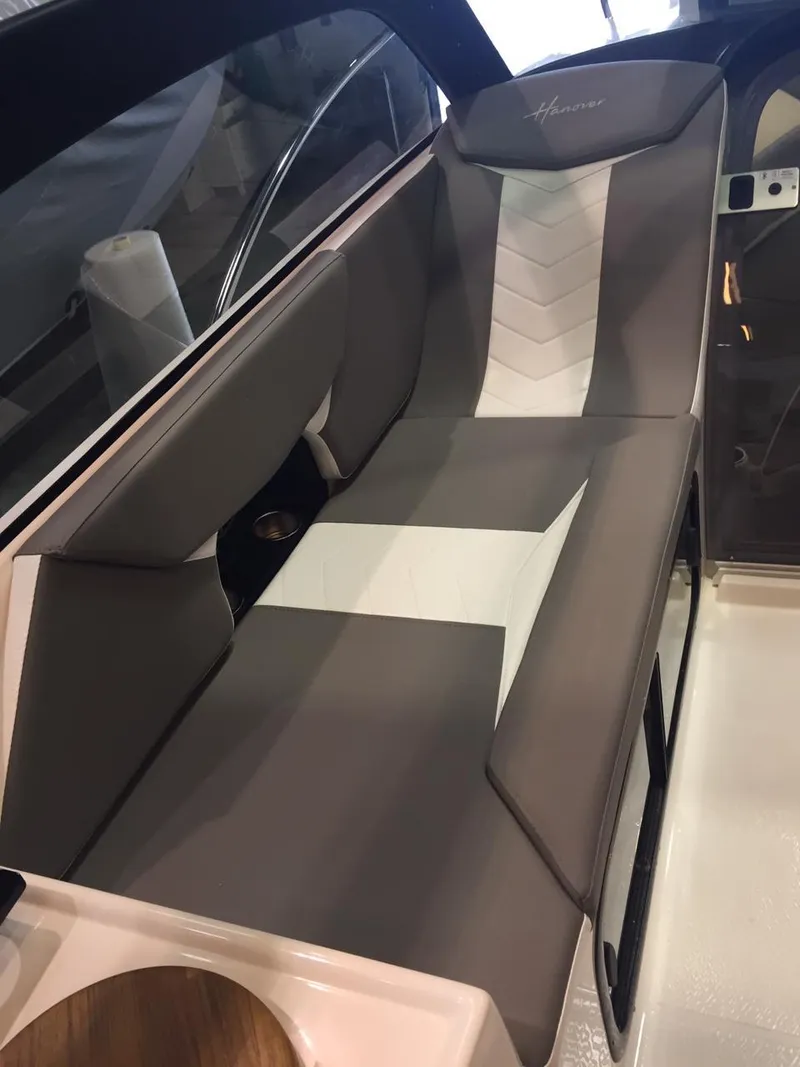 Slide: The Image of Luxurious seating in 2025 Hanover 305 boat, featuring sleek gray and white upholstery. - 10