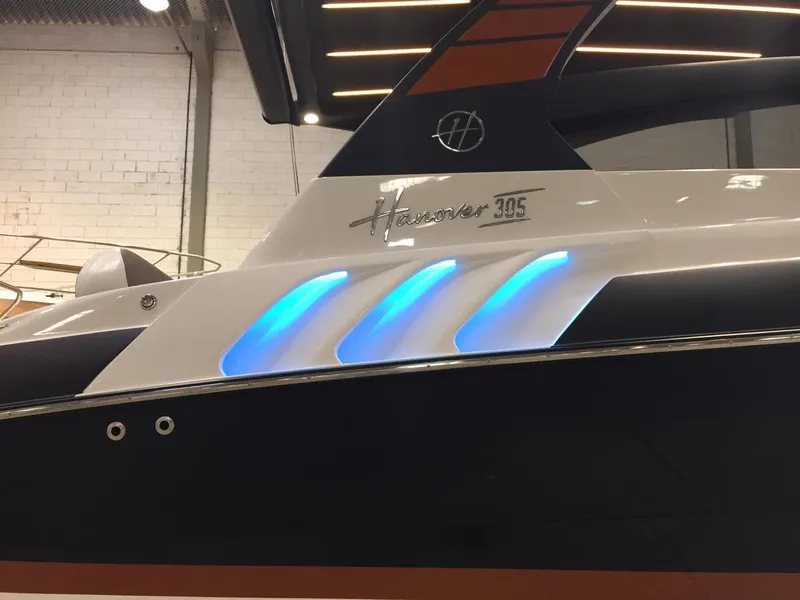 Slide: The Image of Hanover 305 boat, 2025 model, featuring sleek design and blue LED accents. - 2