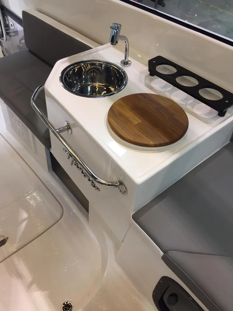 Slide: The Image of Compact kitchenette on Hanover 305 boat, featuring sink, faucet, and wooden cutting board, 2025 model. - 5